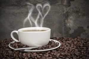 Rustic style setting of hot coffee and coffee beans with heart shape smoke